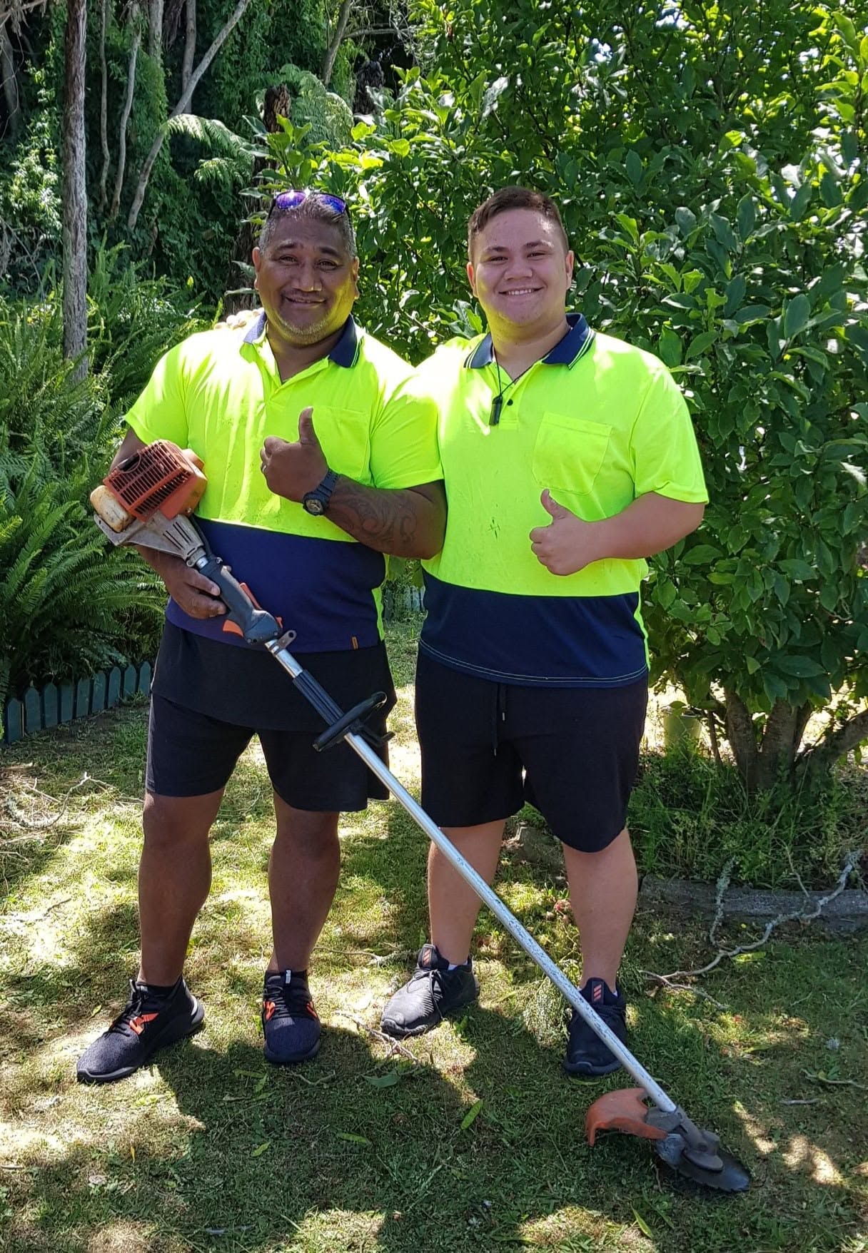 Raki and the MowBro Lawns team in hi-vis with a line trimmer in Ngaruawahia